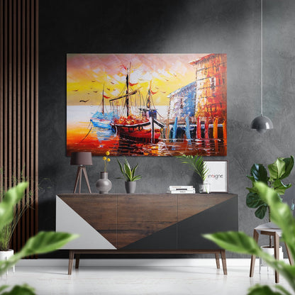 Colorful boat and harbor scene with golden sunset displayed above wooden dresser in modern gray interior with plants.