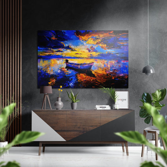 Colorful abstract sunset painting with blue boat on water displayed above wooden credenza in modern interior setting.