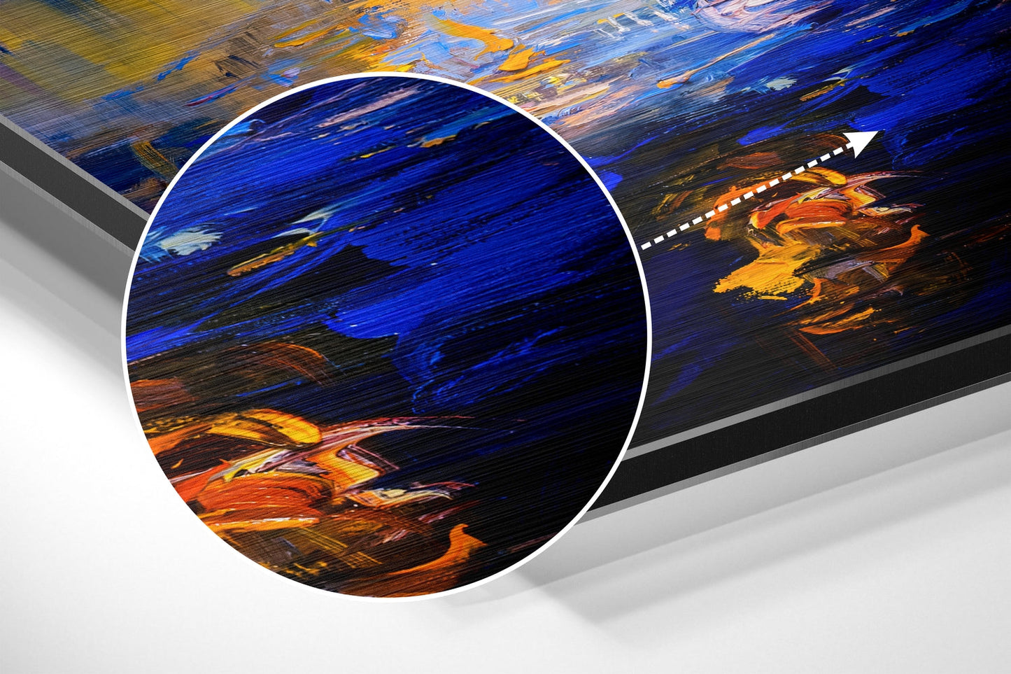 Close-up detail of brushed aluminium wall art showing bold blue, orange, and yellow painted brushstrokes with magnified circular inset.