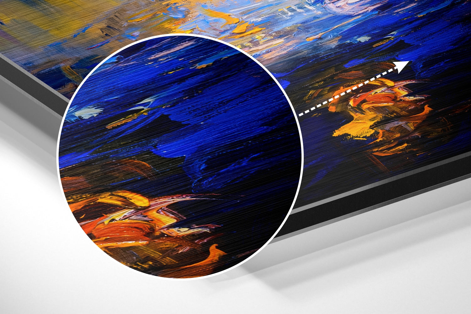 Close-up detail of brushed aluminium wall art showing bold blue, orange, and yellow painted brushstrokes with magnified circular inset.