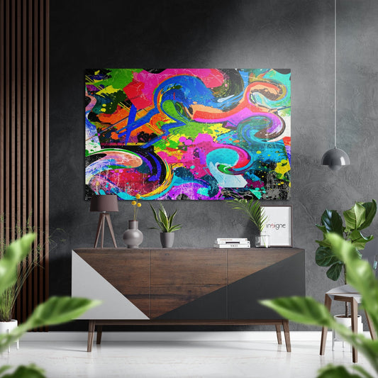 Vibrant neon graffiti wall art with swirling blue, pink, green, and yellow patterns displayed above a wooden mid-century console table in a modern interior.