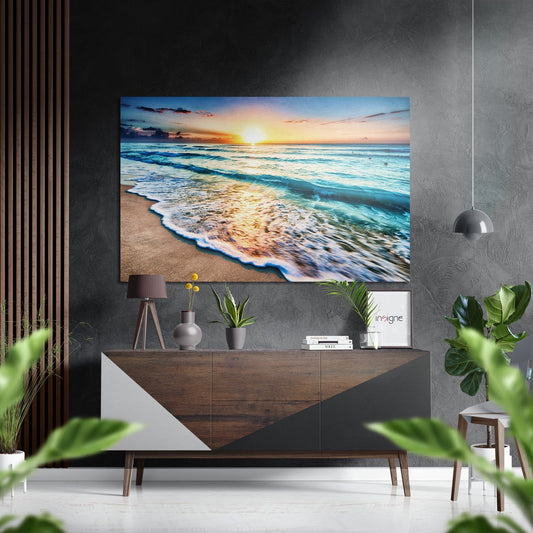 Beach sunset metal wall art displayed above wooden dresser in modern living room with plants and decor.