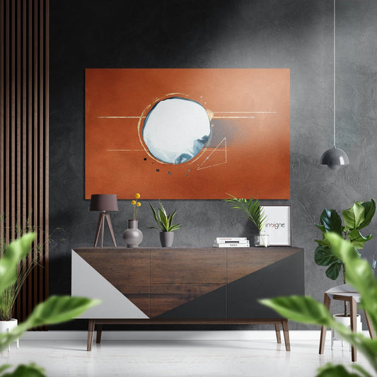 Burnt orange abstract wall art with circular mirror and geometric lines displayed above wooden mid-century dresser in modern interior.