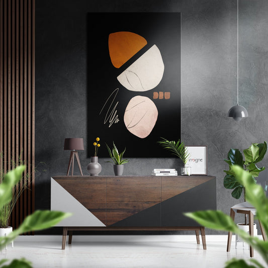 Modern living room with abstract wall art featuring orange and cream shapes on black Dibond, displayed above wooden console table with plants and accessories.