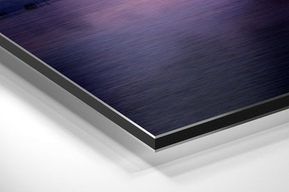 Close-up angled view of layered Dibond wall art showing brushed dark blue top surface with silver and white composite layers beneath.