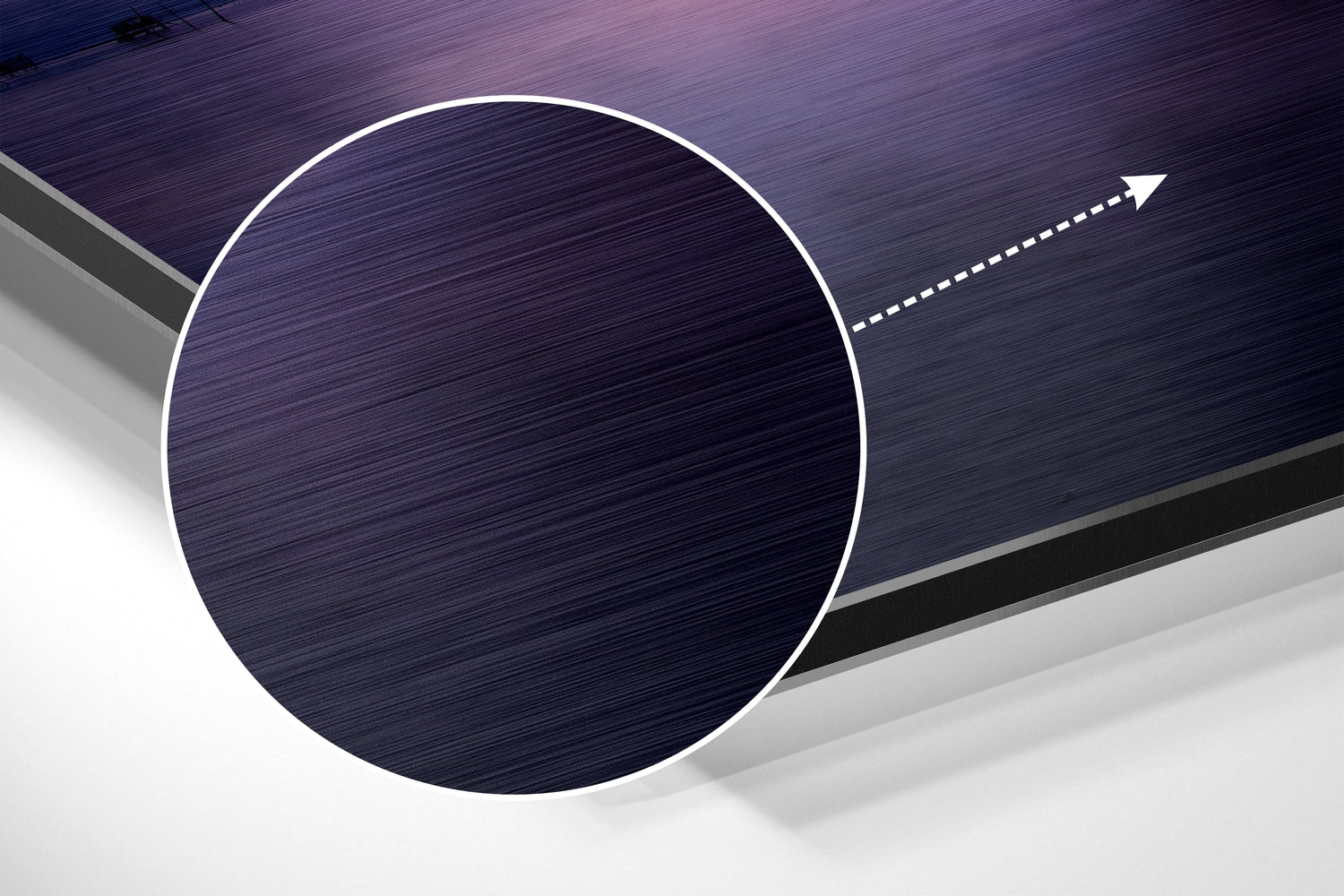 Close-up angled view of brushed aluminum dibond wall art with dark blue textured circular panel and white directional arrow graphic.