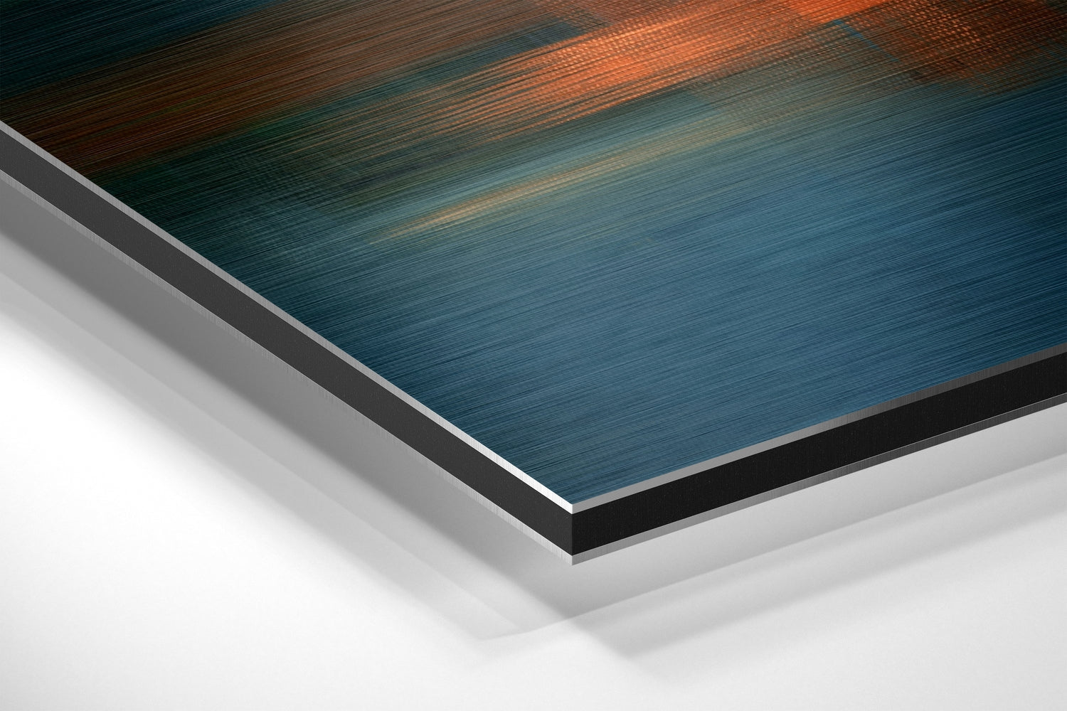 Angled corner view of brushed aluminum Dibond panel displaying gradient colors from teal blue to burnt orange with black and silver edges.