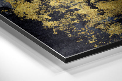Angled close-up of black and gold brushed aluminium Dibond wall art showing layered edge construction and metallic finish detail.