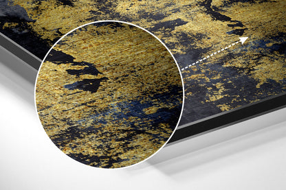 Close-up detail of gold brushed aluminum surface with black streaks and blue undertones, circled magnification view.