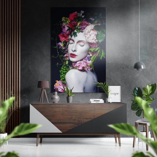 Modern interior setting featuring a portrait of a woman with colorful flowers adorning her head and neck, displayed above a wooden console table.
