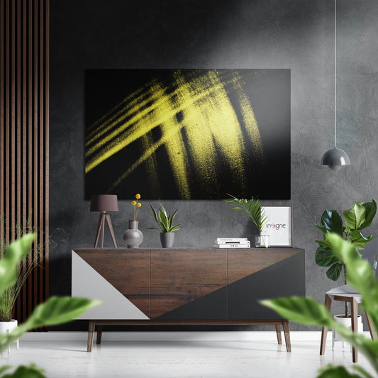 Yellow brushstroke abstract art displayed above wooden sideboard in modern interior setting with plants and pendant lamp.