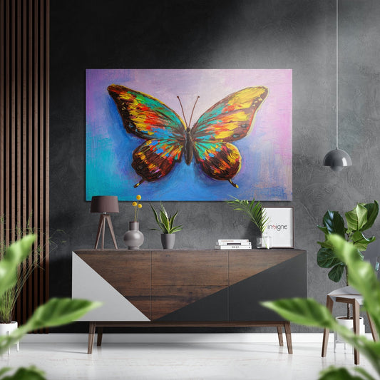 Colorful rainbow butterfly artwork hung above a wooden sideboard in a modern living room with plants and pendant lighting.