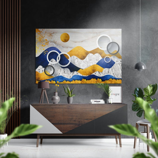 Modern living room interior featuring abstract blue, gold, and white mountain landscape wall art with geometric circles above a wooden console table.