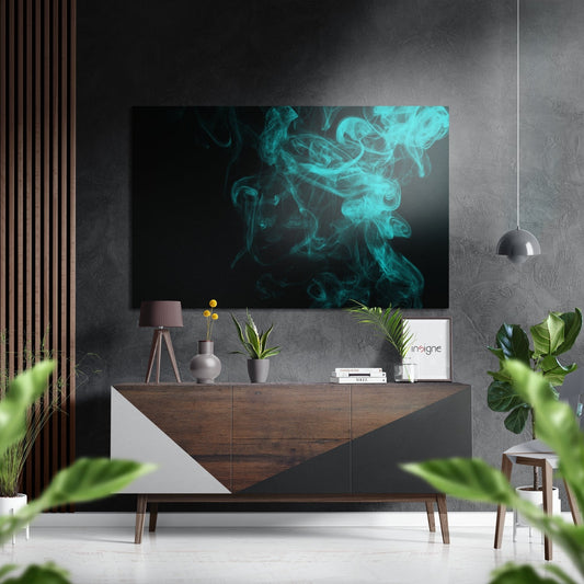 Turquoise swirling smoke artwork displayed above a wooden sideboard in a modern living room with gray walls and potted plants.