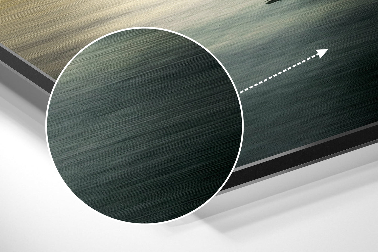 Close-up angled view of brushed aluminium Dibond wall art showing circular green textured disc with white border and directional arrow.