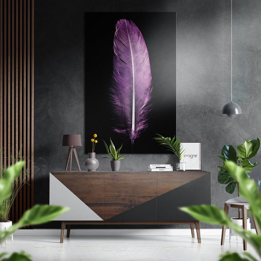 Purple feather artwork displayed above wooden dresser in modern living room with plants and pendant lamp.