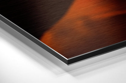 Close-up angled view of layered Dibond panel showing red-brown brushed metal surface with black and silver edge layers against white background.