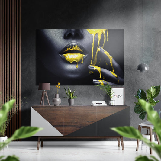 Modern interior display featuring yellow ink brushed aluminium wall art of a woman's face above a wooden console table with plants and pendant lighting.