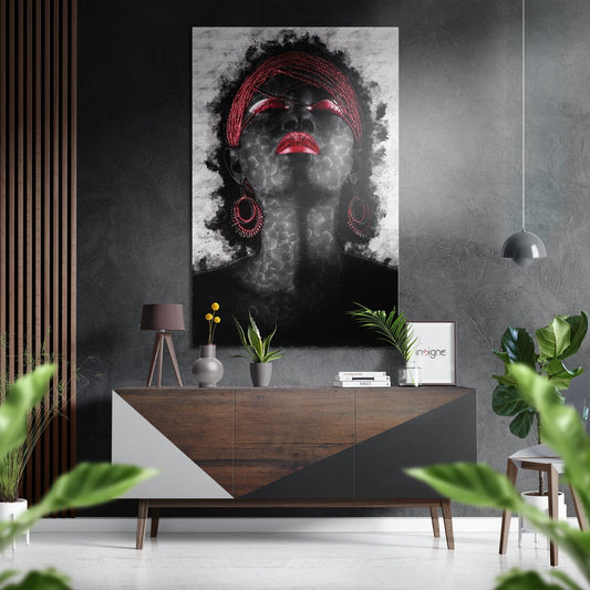 Modern interior with black and white portrait featuring red lips, braids, and earrings displayed above wooden sideboard.