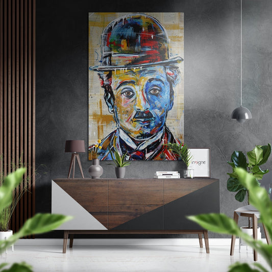Colorful portrait of man in bowler hat displayed on gray wall above wooden console table in modern interior setting.