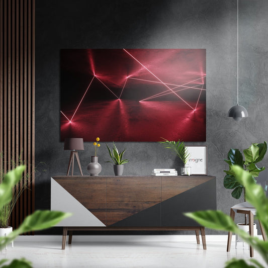 Red neon geometric line art displayed above wooden console in modern living room with plants and pendant lamp.