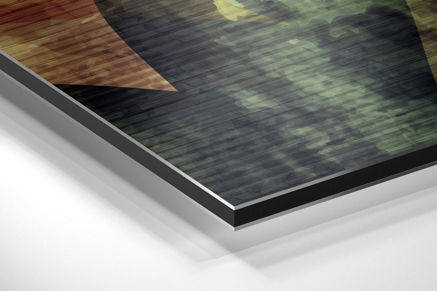 Angled close-up view of brushed aluminium Dibond wall art showing layered edges with black border and white backing board.