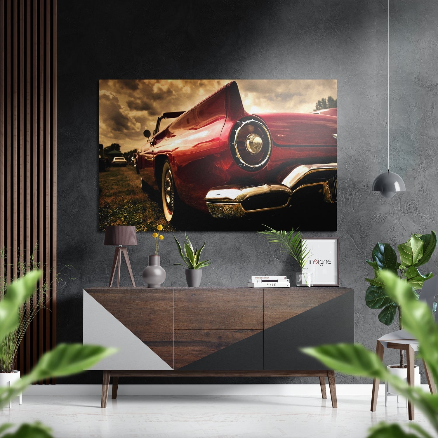 Red vintage convertible sports car with raised hood displayed on brushed aluminium wall art in modern interior setting.