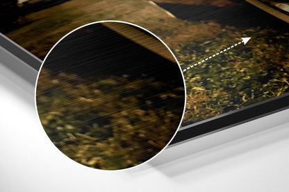 Close-up detail of brushed aluminium surface with circular white-bordered cutout revealing textured wood grain background and directional arrow.