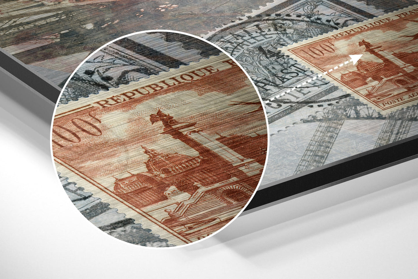 Close-up detail of red and cream banknote artwork with "REPUBLIQUE" text visible on brushed aluminium surface.