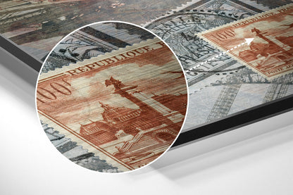 Close-up detail of red and cream banknote artwork with "REPUBLIQUE" text visible on brushed aluminium surface.