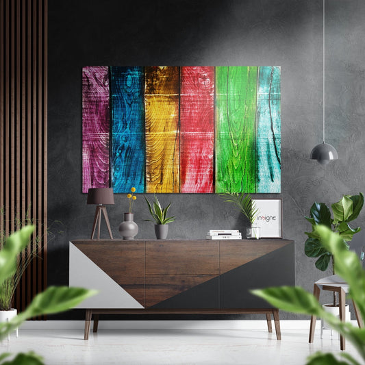 Modern room interior featuring six vertical rainbow-colored wooden panels with wood grain texture mounted above a mid-century style credenza.