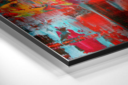Angled perspective view of vibrant abstract wall art with red, cyan, and orange brushstrokes on brushed aluminum Dibond panel.