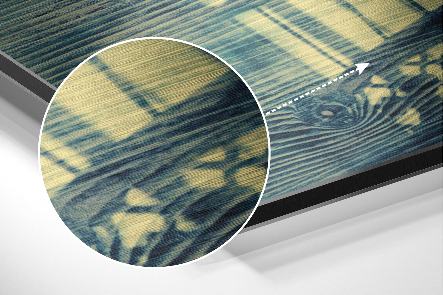 Close-up detail view of brushed aluminium surface showing blue and gold striped pattern with magnified circular inset highlighting texture.
