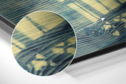 Close-up detail view of brushed aluminium surface showing blue and gold striped pattern with magnified circular inset highlighting texture.