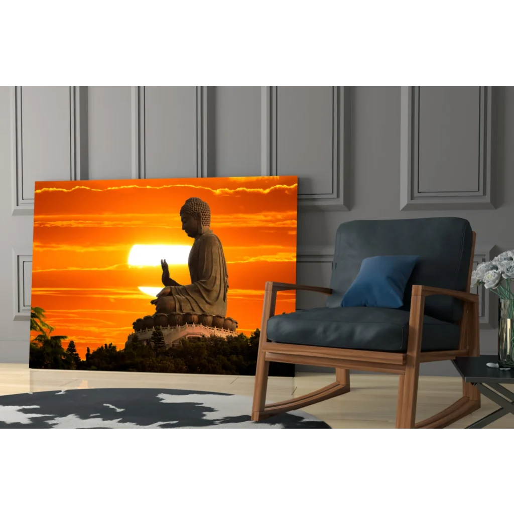 Golden Buddha silhouette in glass wall art against orange sunset