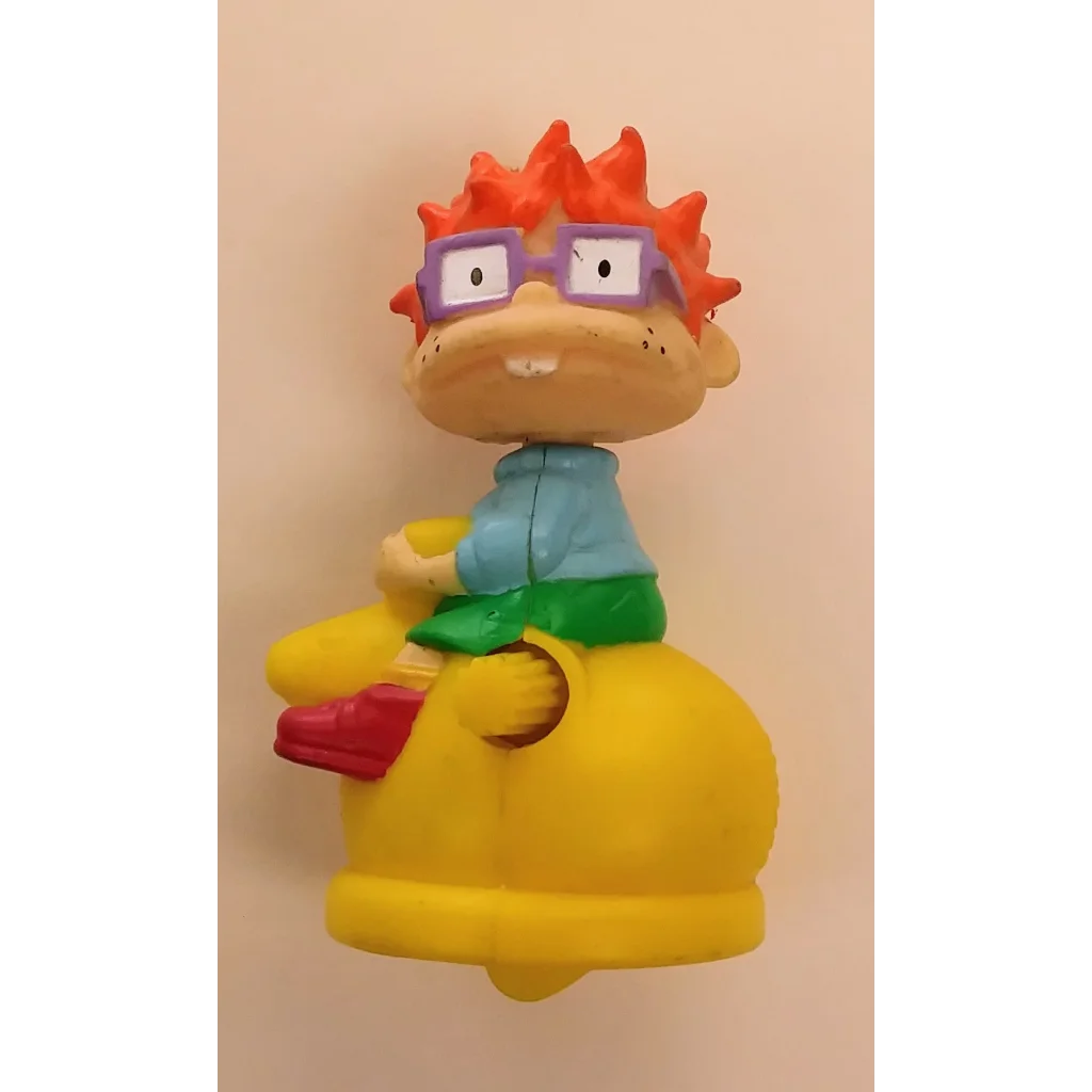 Vintage Burger King Kids Club Chuckie Rugrats wind-up toy with yellow green figure, purple glasses, red spiky hair, blue shirt, white face