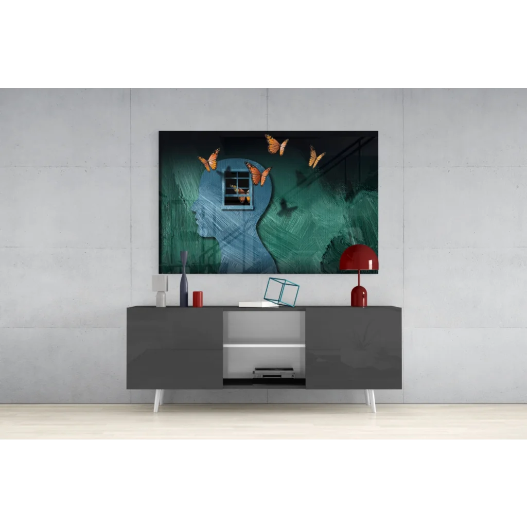 Stylized blue head silhouette with orange butterflies on teal glow glass wall art