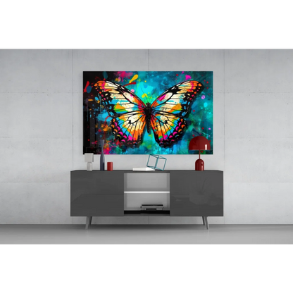 Vibrant butterfly glass wall art with iridescent orange pink teal wings on splattered background