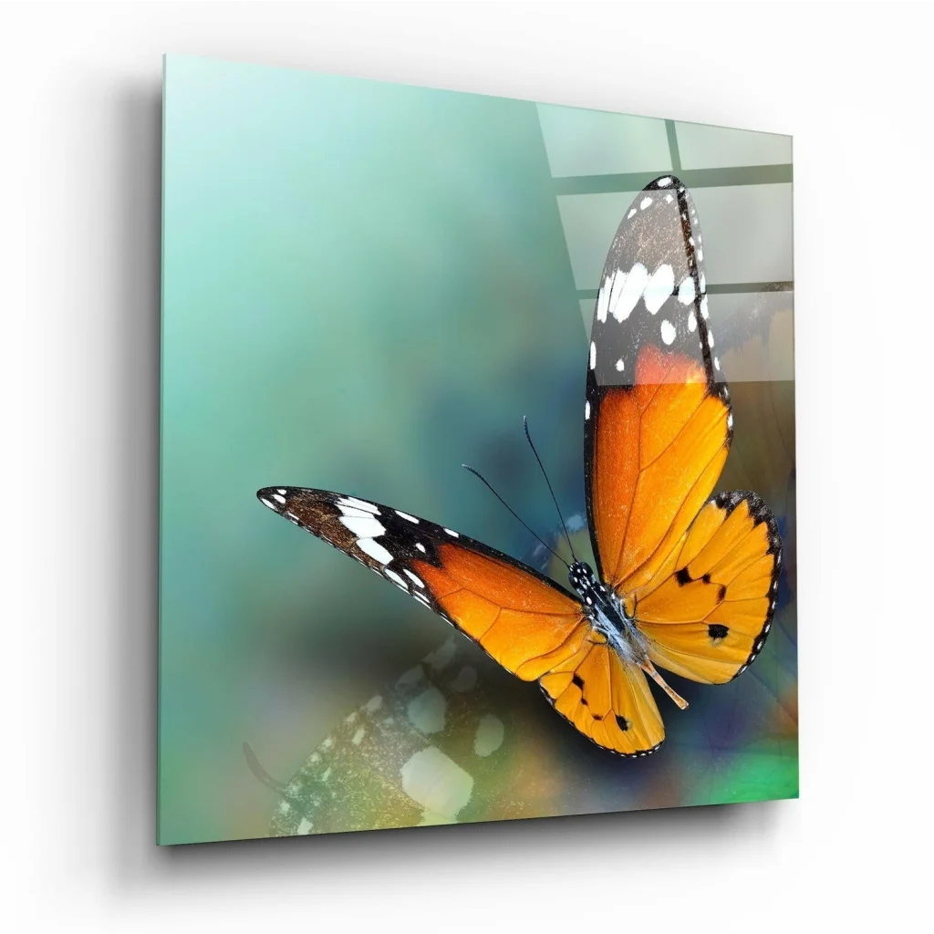 Vibrant orange black butterfly glass wall art with white spots and rainbow glow