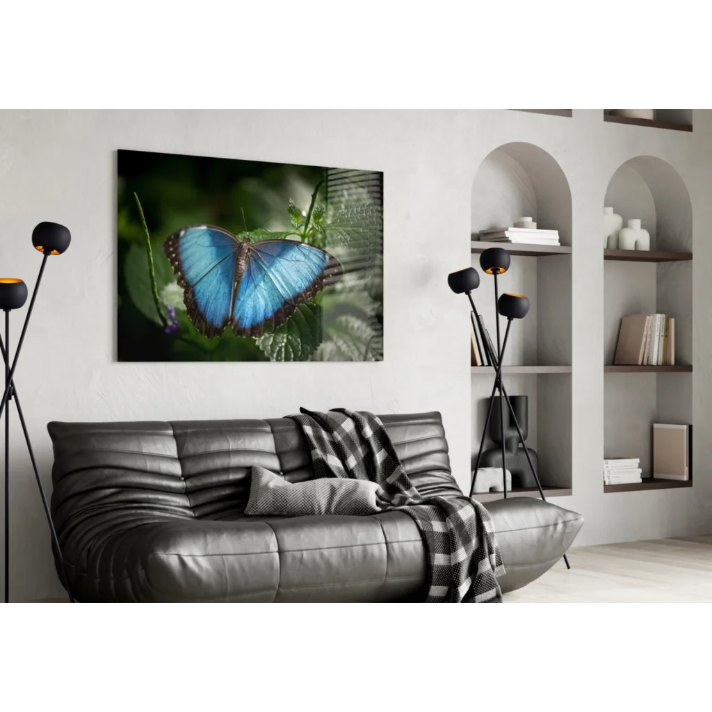 Vibrant blue morpho butterfly on green foliage in glass wall art print