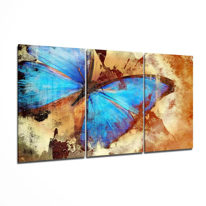 Vibrant blue butterfly glass wall art triptych on textured panels