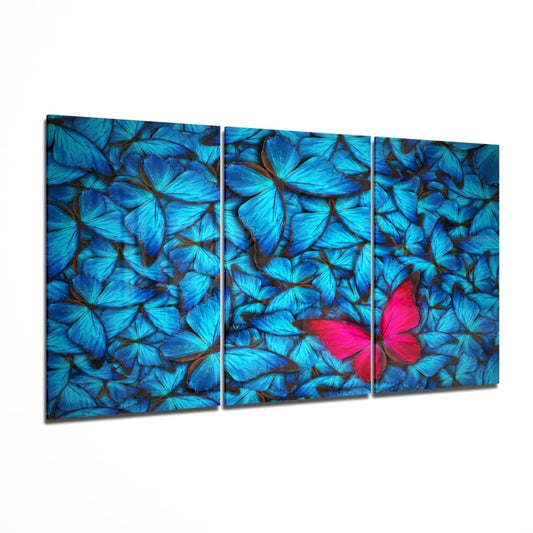 Vibrant pink butterfly in insigne glass art triptych with blue backdrop