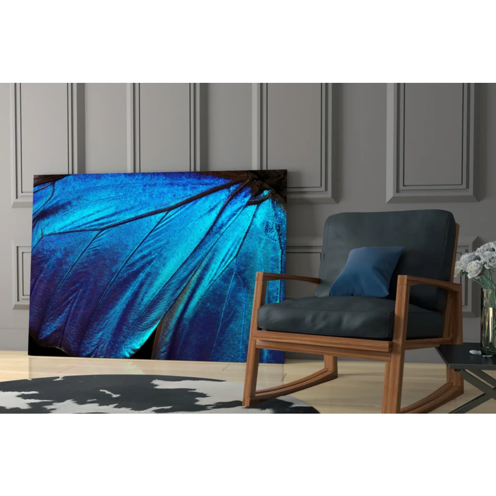 Vibrant blue butterfly wing glass wall art with iridescent texture