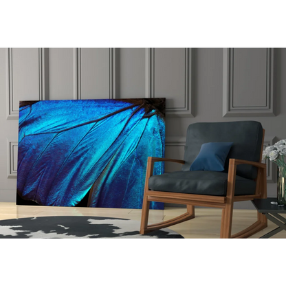 Vibrant blue butterfly wing glass wall art with iridescent texture