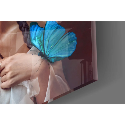Vibrant blue butterfly on womans arm in glass wall art print