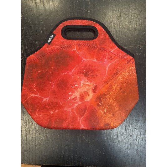 Red neoprene insulated lunch bag with marbled texture and black trim, displayed flat on dark wooden surface.