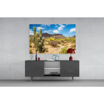 Vibrant desert glass wall art with cacti and mountains under blue sky