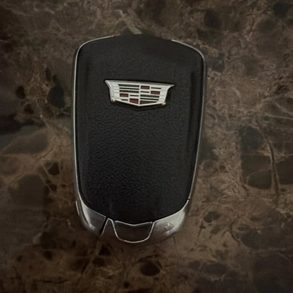 Black textured Cadillac XT4 2019 key fob with silver trim