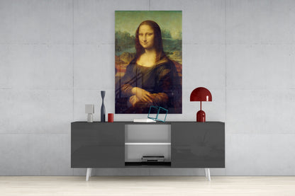 Mona Lisa glass wall art displayed above a gray console table with white legs, styled with decorative objects including a red lamp and small sculptures.