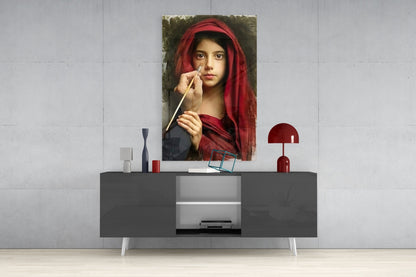 Portrait glass wall art depicting a young woman in red headscarf holding a paintbrush, displayed above modern gray console table.